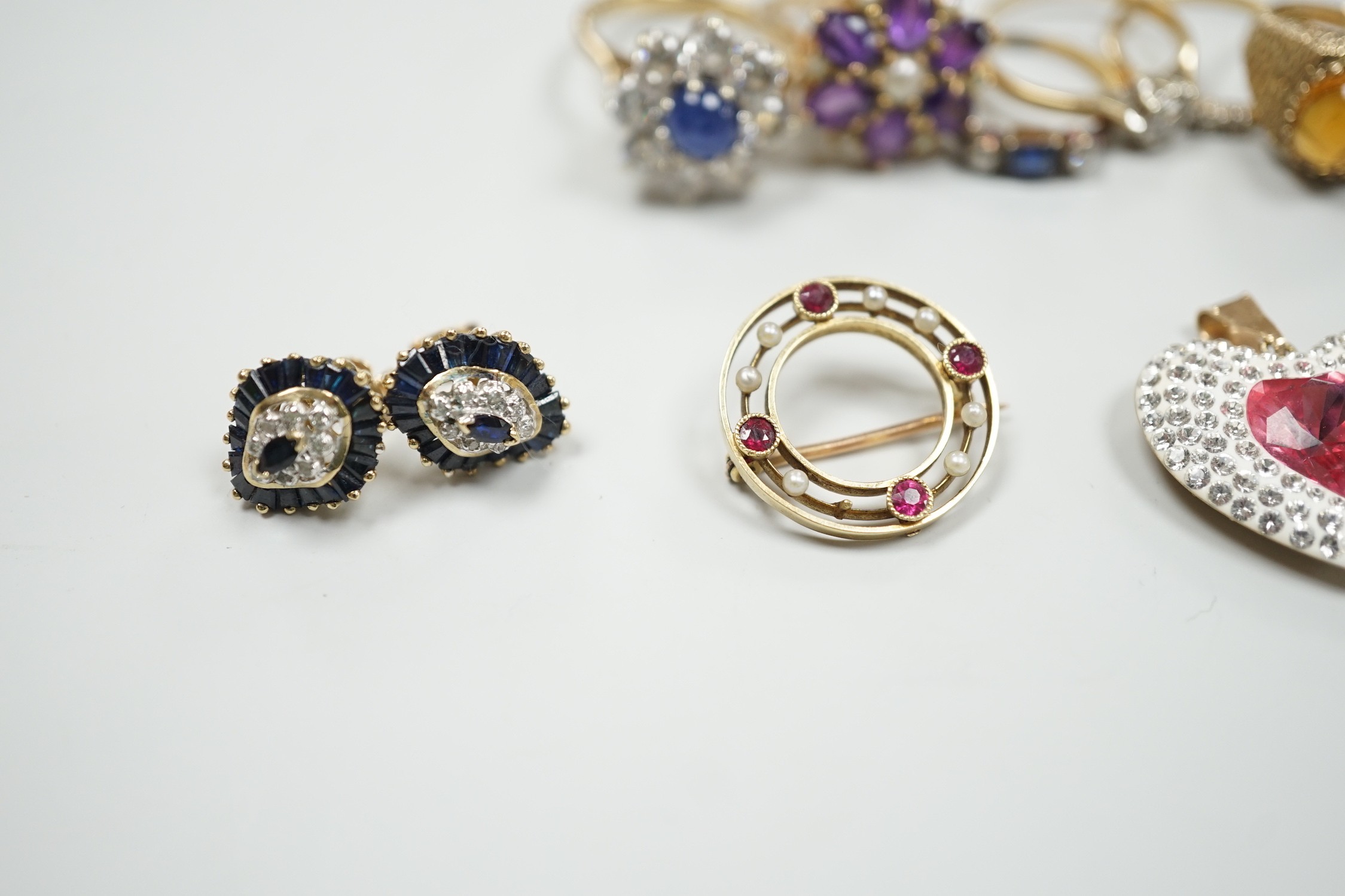 Eight assorted mainly modern 9ct gold and gem set dress rings, including amethyst and split pearl cluster, gross weight 30.7 grams, a 15ct, ruby and seed pearl set open work circular brooch, gross 2.6 grams, pair of 9ct,